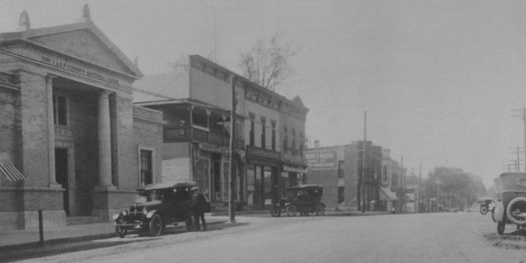 Two employees standing in front of their coffee shop